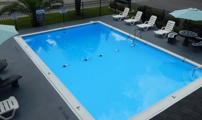 a pool with chairs around it