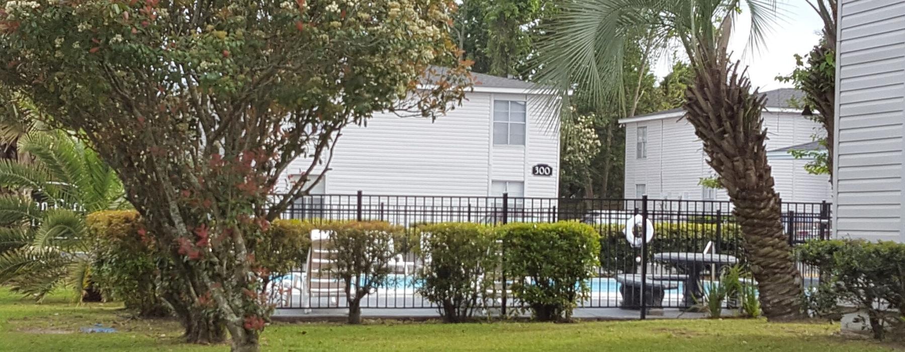 a house with trees and bushes in front of it