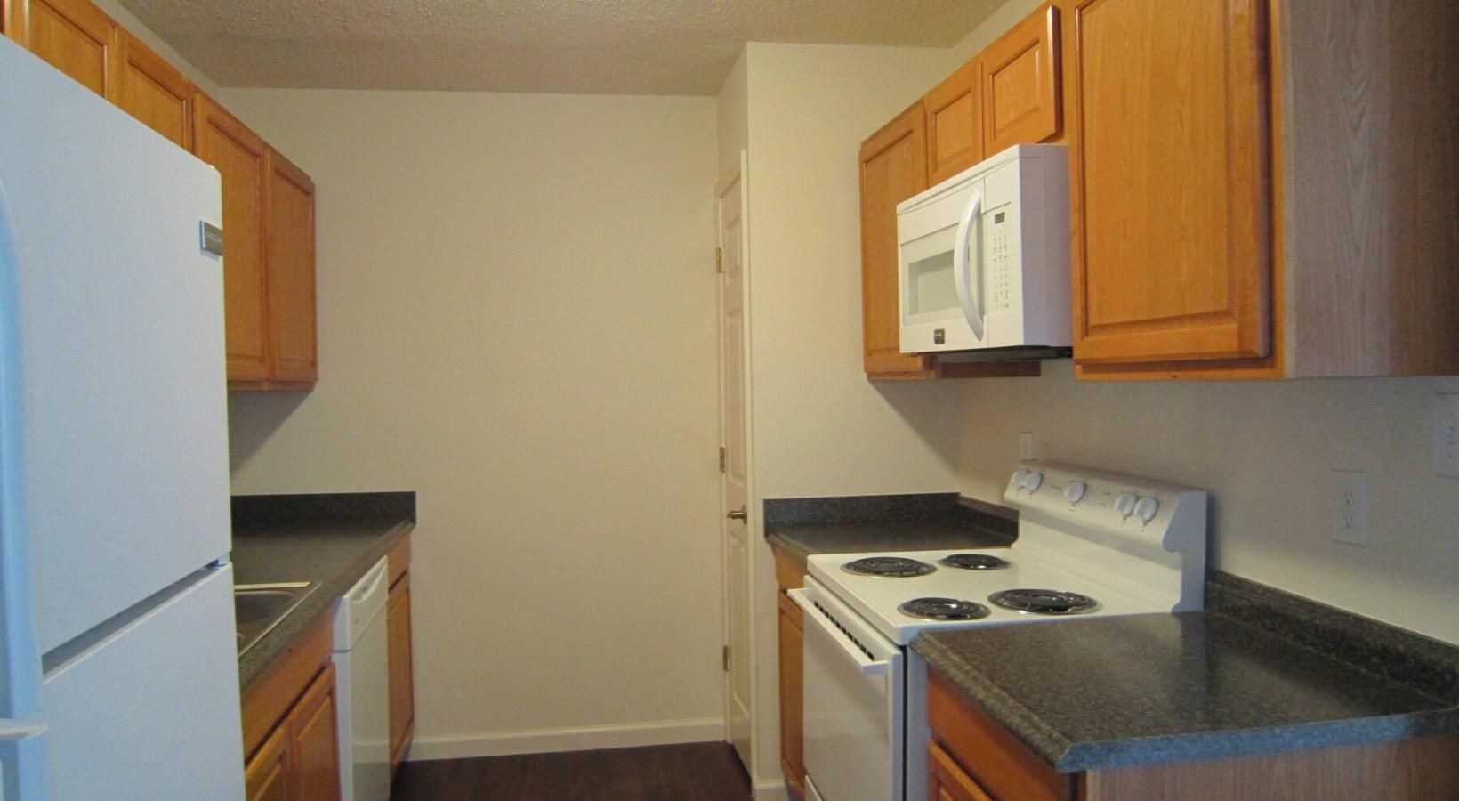 a kitchen with wooden cabinets