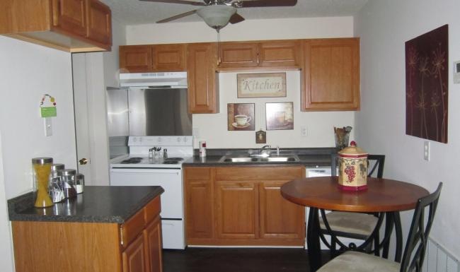 a kitchen with a table and chairs